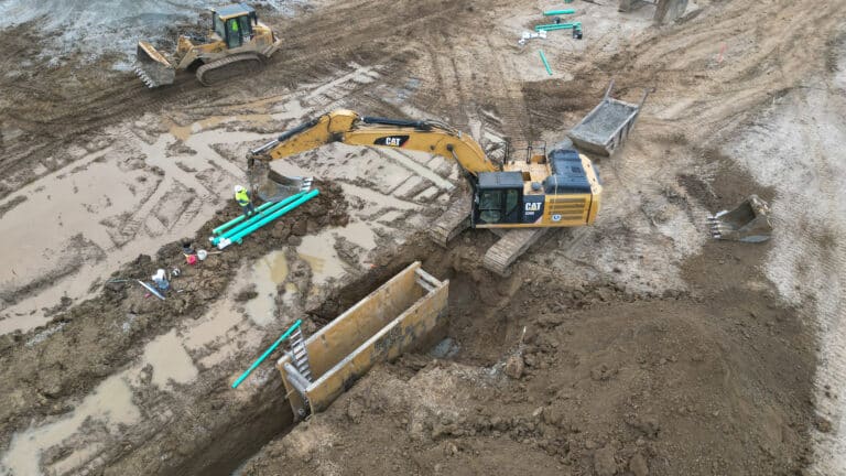 Excavator trenching at Lebanon, IN job site.